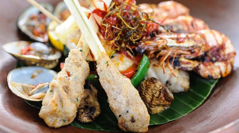 Indonesian-style seafood with grilled fish prawns and clams Indonesian-style seafood with grilled fish prawns and clams