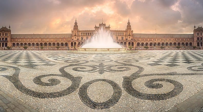 View of Palza de Espana in Seville with mosaic in foreground and cloud sky, Andalusia, Spain. View of Palza de Espana in Seville with mosaic in foreground and cloud sky, Andalusia, Spain.