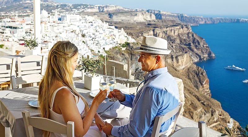 A couple having dinner outside in Santorini, Greece. A couple having dinner outside in Santorini, Greece.