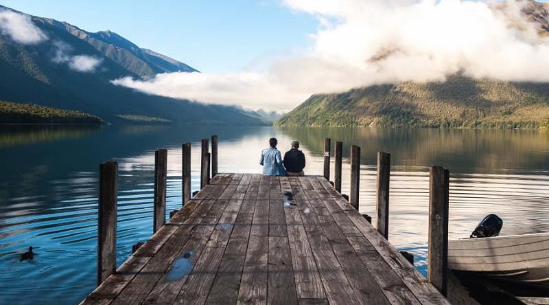 Couple sitting on the pier at Nelson Lake National Park Couple sitting on the pier at Nelson Lake National Park