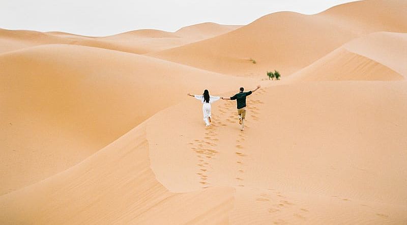 Couple at the Sahara desert in Morocco