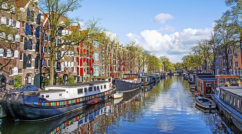 Dutch buildings and canal in Amsterdam, Netherlands