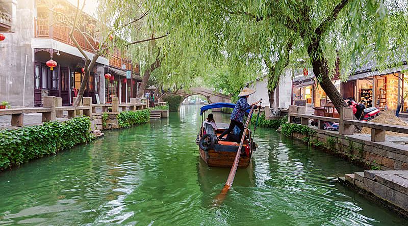 Gondola runs on the canals near Shanghai in China. Gondola runs on the canals near Shanghai in China.