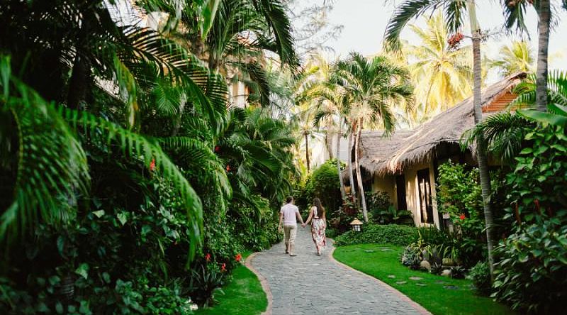 A couple walking through a beach resort in Vietnam.
