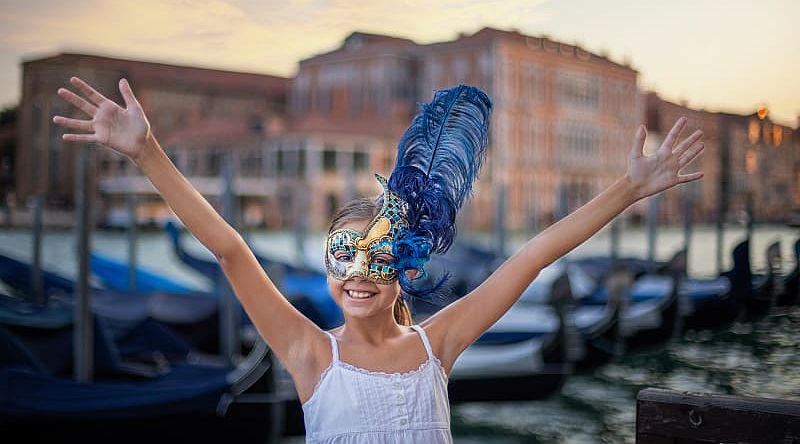 The Wonders of Italy Family-Friendly Tour - Venice, Italy Young girl wearing carnival mask in Venice, Italy