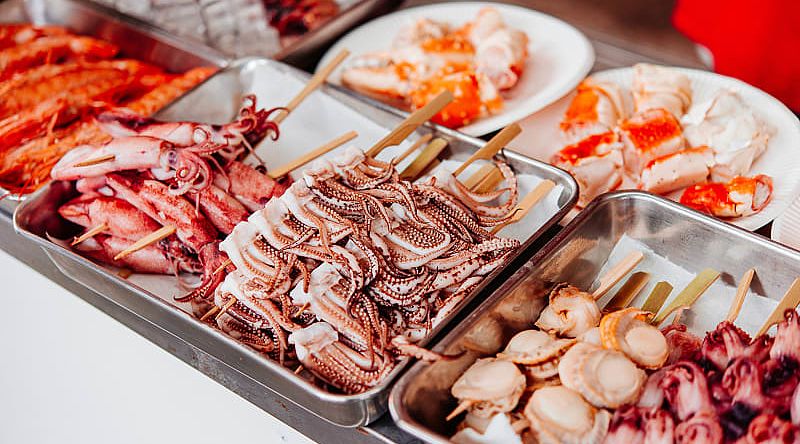 Visit the Tsukiji Fish Market, Tokyo, where top sushi chefs buy fresh seafood.