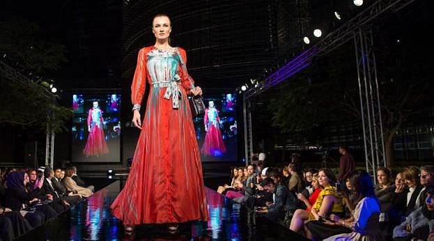 Runway model in a red dress at a fashion show. Credit: Ahmad Ardity Runway model in a red dress at a fashion show. Credit: Ahmad Ardity