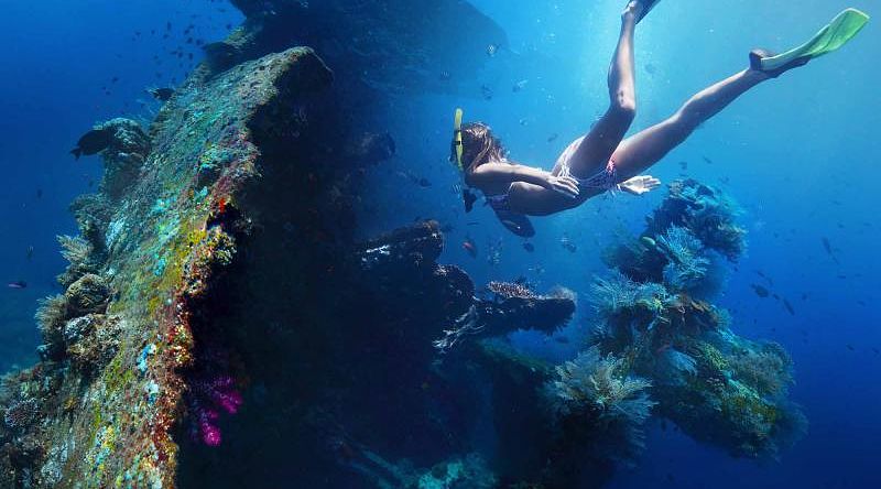 Cultural Immersive Bali Vacation for Active Travelers Woman exploring USAT Liberty wreckage off the coast of Bali