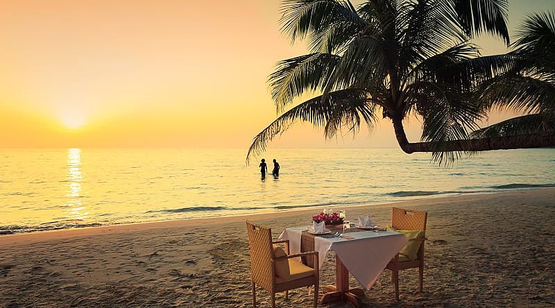 Honeymoon couple enjoying a romantic dinner on the beach in Costa Rica