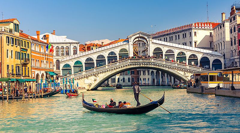 Gondola ride near the Rialto Bridge on the Grand Canal in Venice, Italy