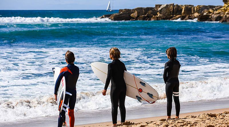 A family surfing in Cascais, Portugal. A family surfing in Cascais, Portugal.