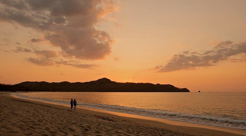 Immerse yourself in the romantic charm of Costa Rica as you stroll along a deserted beach together Immerse yourself in the romantic charm of Costa Rica as you stroll along a deserted beach together