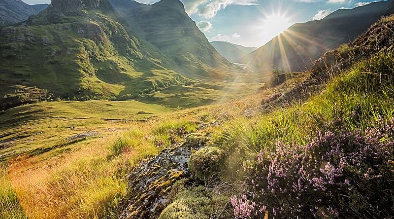 Sun peaking over the mountain in the Scottish highlands.