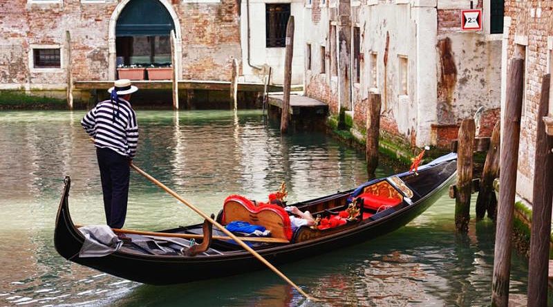 Gondolier on Venice canal in Italy Gondolier on Venice canal in Italy