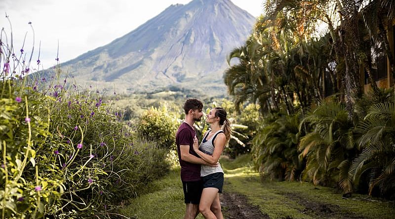 Couple with the Arenal volcano in the background in Costa Rica