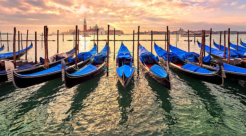 Gondolas on Venice canal at sunset