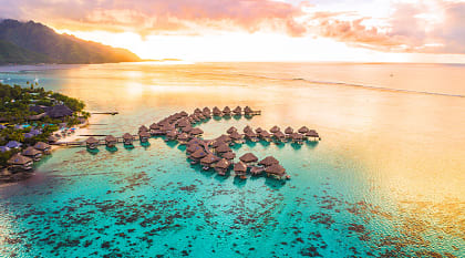 Overwater bungalows along coral reef in Moorea, French Polynesia