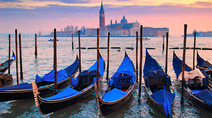 Gondolas on Venice canal at sunset in Italy Gondolas on Venice canal at sunset in Italy