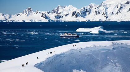 Tourists hiking on glacier during an excursion in Antarctica