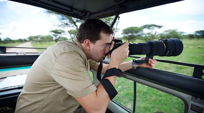 Photographer on game drive in the African savannah