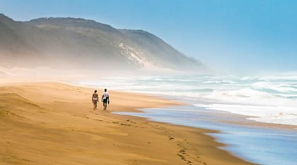 Couple walking on the beach in Saint Lucia, South Africa Couple walking on the beach in Saint Lucia, South Africa