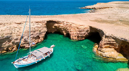 Private yacht anchored at Ksylobatis caves near Koufonisi, Cyclades, Greece.