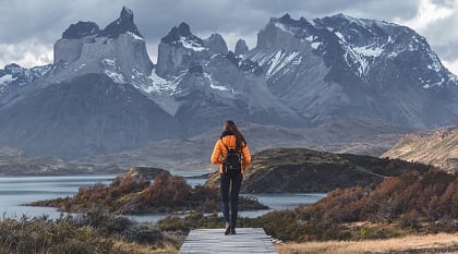 Torres del Paine National Park in Patagonia, Chile Hiker walking toward Torres del Paine peaks in Patagonia, Chile.