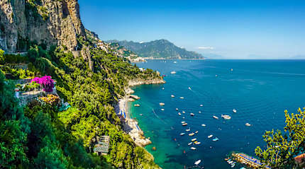 Postcard view of steep mountain cliffs and azure waters in the Amalfi Coast of Italy