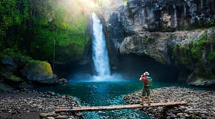Hiker enjoying a waterfall in Bali, Indonesia