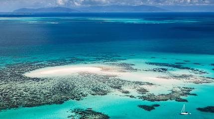 Breathtaking aerial view of the Great Barrier Reef, showcasing vibrant coral formations and turquoise waters in Queensland, Australia
