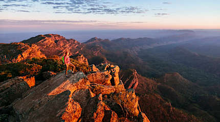 Woman hiking St Mary Peak in Flinders Ranges National Park, Australia