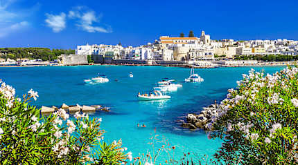 Boats in the crystal blue waters of Otranto in Puglia, Italy.