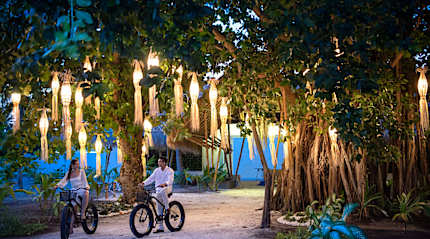 Couple fat biking around Fasmedhoo Island in the Maldives