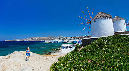 Girl and windmills in Mykonos