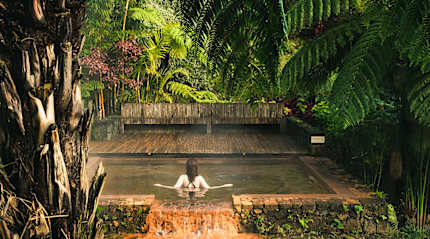Female tourist enjoying hot springs pool at Poca da Dona Beija on Sāo Miguel, Azores
