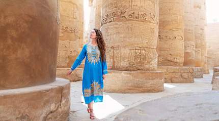 Woman marveling at hieroglyphics in Luxor, Egypt