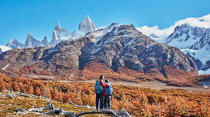Brothers admiring the snowy peaks of Mount Fitz Roy, Patagonia, Argentina, during autumn