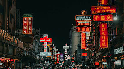 Neon-lit Chinatown street where Southeast Asia's street food culture thrives