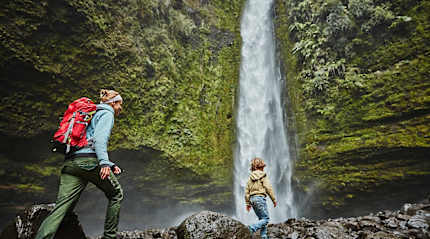 Mother and son on family vacation at Las Cascadas Waterfall in Chilean Patagonia