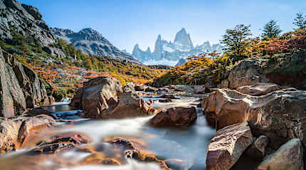Stream and autumn colors in El Chalten with Fitz Roy mountain in Argentina