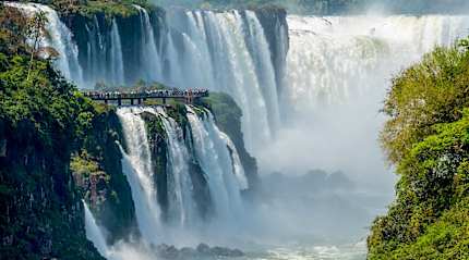 Travelers viewing The Devil's Throat from a platform on the Argentinian side of Iguazu Falls 