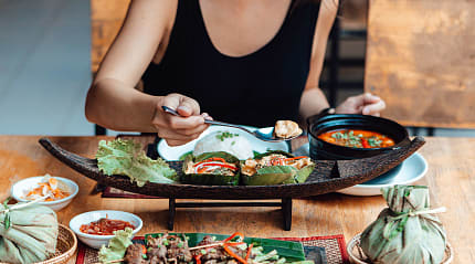 Woman enjoying mouthwatering Thai Cuisine