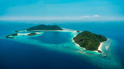 Tropical island surrounded by crystal-clear turquoise waters.