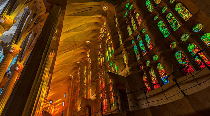 Afternoon light streaming through the stained glass windows of La Sagrada Familia in Barcelona, Spain