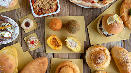 Selection of Sicilian street foods on a table in Sicily, Itlay