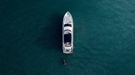 Aerial view of a luxury yacht anchored in turquoise water