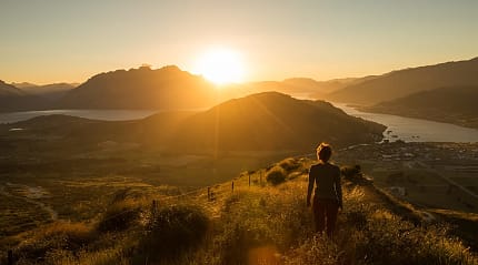 Watching the sun set behind the mountains in Queenstown, New Zealand