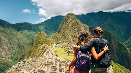 Couple at the gret Inca city of Machu Picchu in Peru