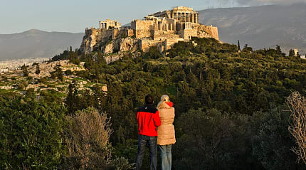 A couple admires the Acropolis in Athens