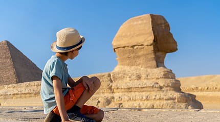 Young boy looking at the Great Sphinx of Giza in Egypt